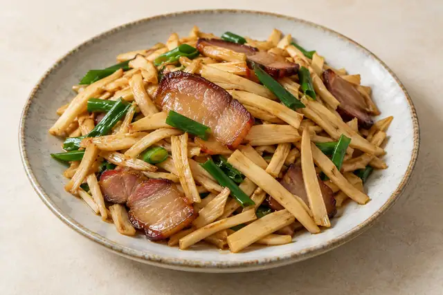 AI illustration: A plate of stir-fried bamboo shoot strips with thin smoked pork-belly slices.