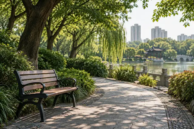 AI illustration: A medium view of a simple wooden park bench beside a curving paved path, mature shade trees.