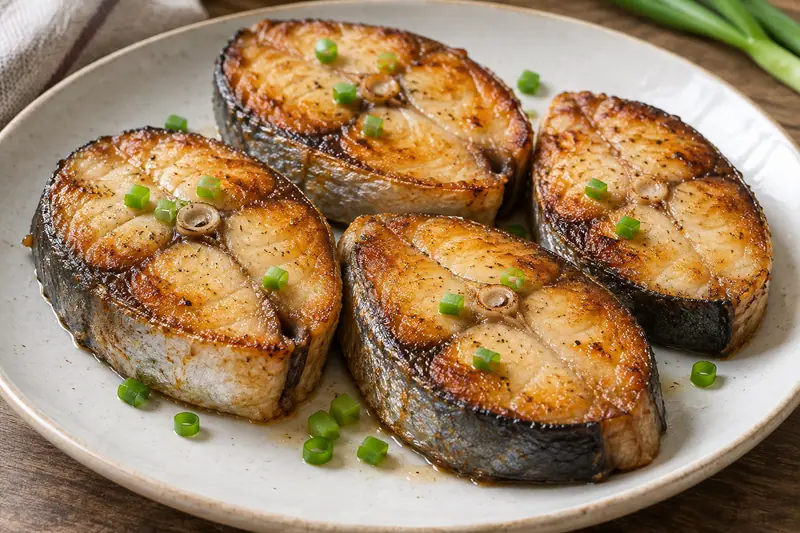 AI illustration: Golden pan-fried Spanish mackerel steaks.