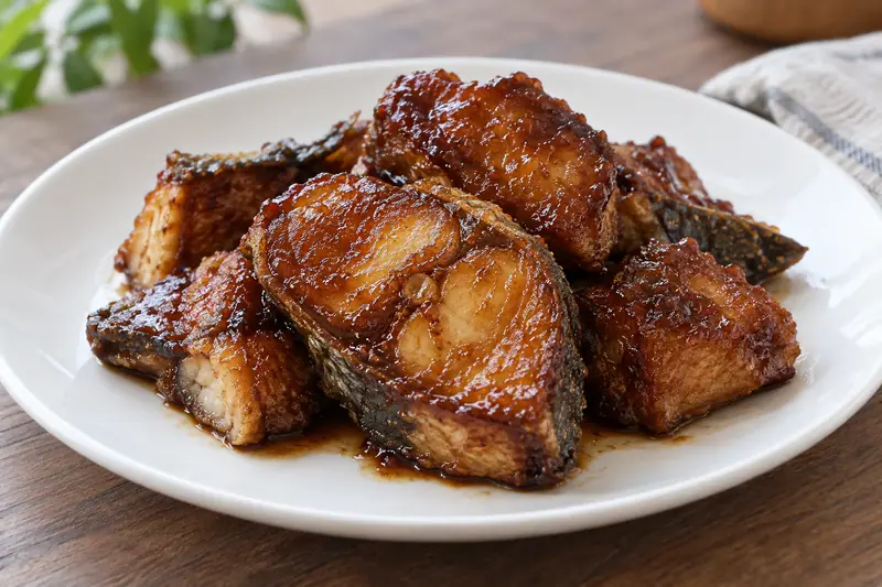 AI illustration: Fried fish pieces glazed with Shanghai-style sweet soy sauce.