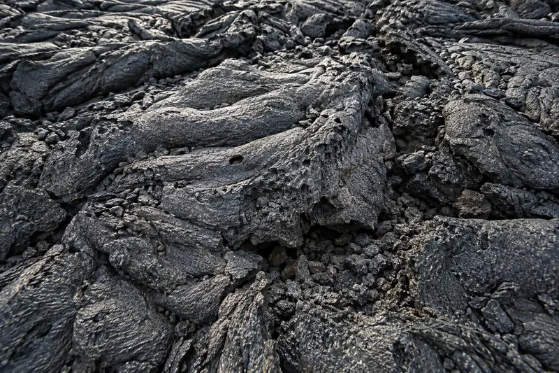 AI illustration: Vesicular volcanic lava surface.