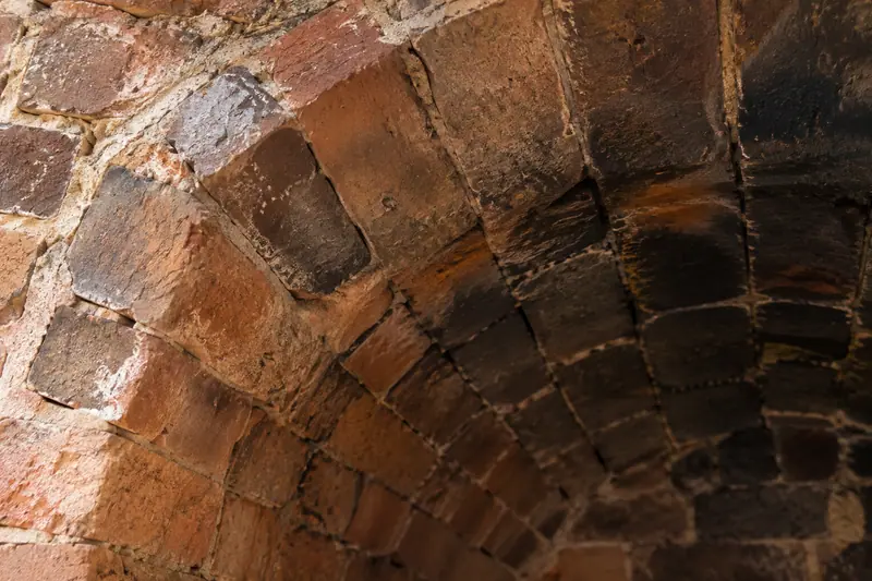 AI illustration: Aged ceramic kiln firebricks with soot and heat marks