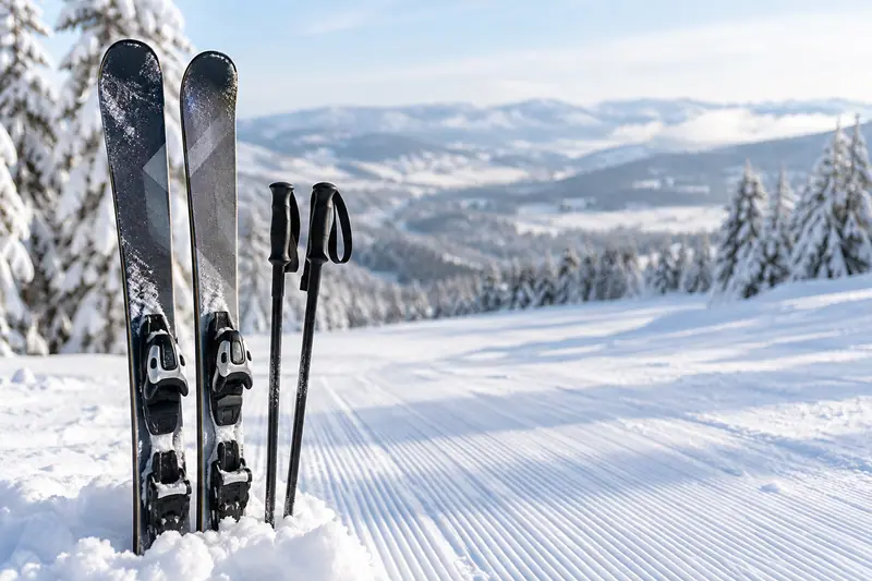 AI illustration: A medium close view of a pair of modern skis and ski poles resting at the edge of a groomed snowy ski.