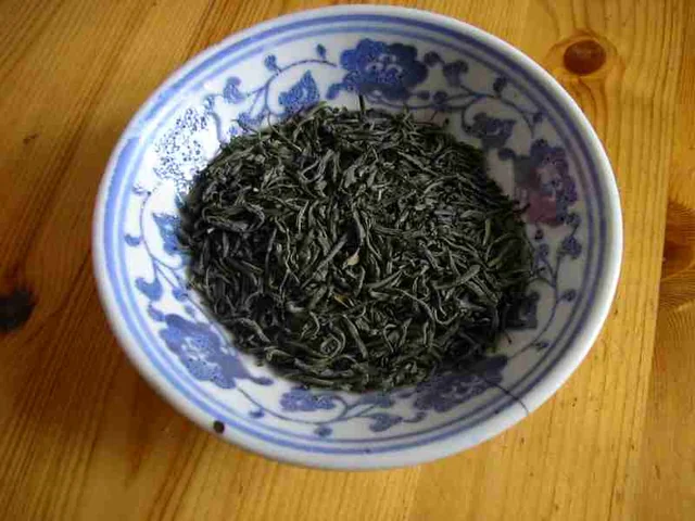 Maojian green tea leaves; the source categorizes this photograph as Xinyang Maojian.