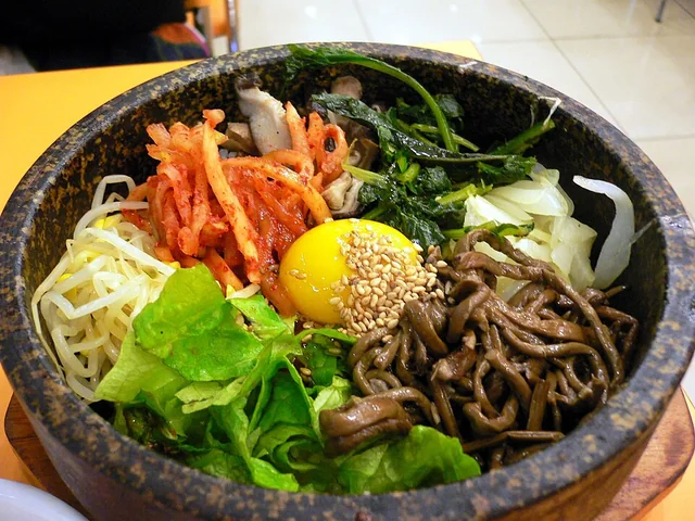 Dolsot bibimbap: rice, vegetables and egg in a heated stone bowl.