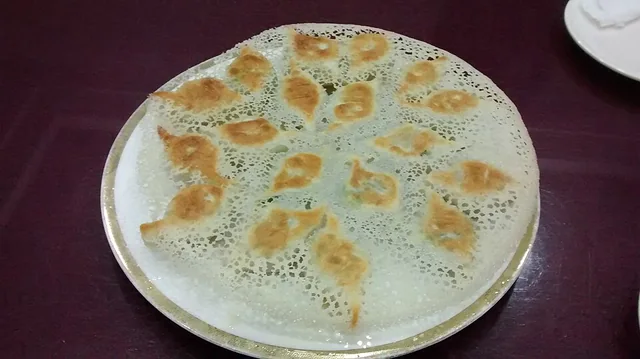 Pan-fried Laobian dumplings under a crisp, lace-like crust.