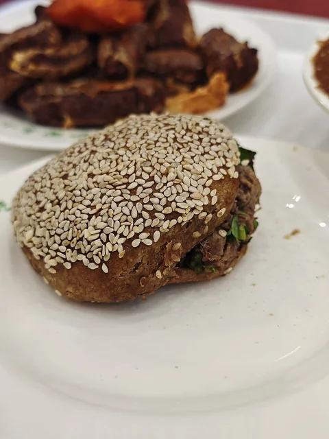 Sesame-covered shaobing filled with sliced beef; this example was photographed in Beijing.