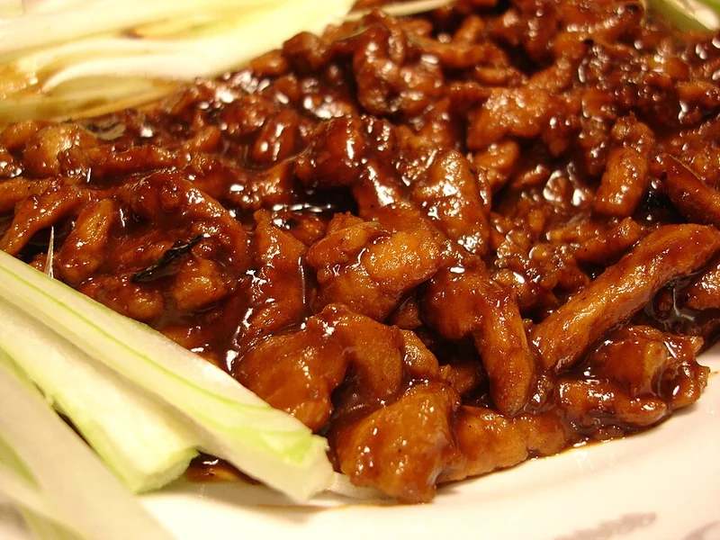 Jing jiang rou si, with no specific restaurant established by the source