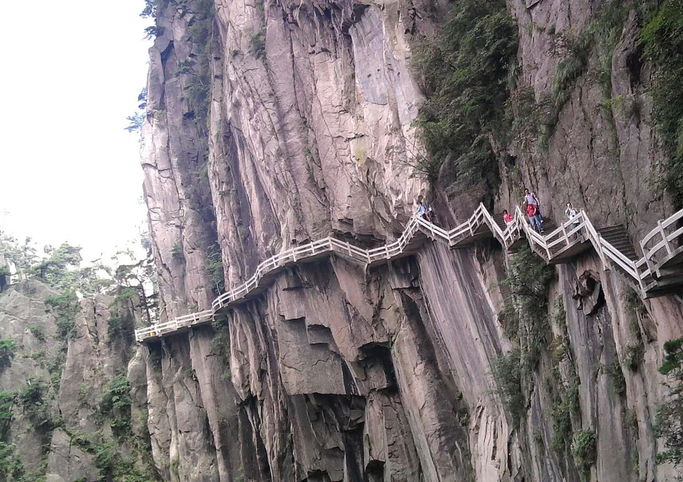 Hikers on a stepped cliff path in Huangshan