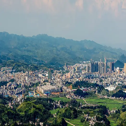Xingren City (兴仁市) — representative view · 群山围绕的密集城镇建筑