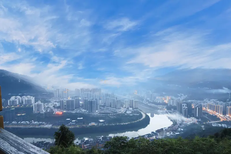 Pingchang County (平昌县) — representative view · 河流转弯处的城市楼群和远山
