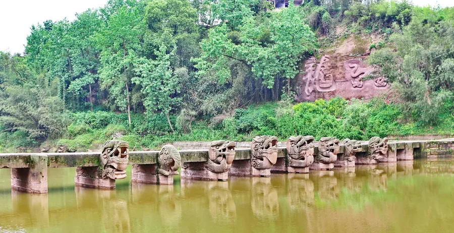The carved animal-headed piers of Longnao Bridge over the river in Luxian, Luzhou, Sichuan; 25 April 2016.