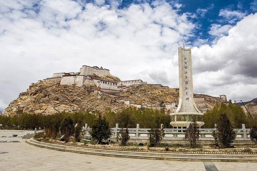 Gyantse Dzong above the town, with the memorial in the foreground, May 2014.