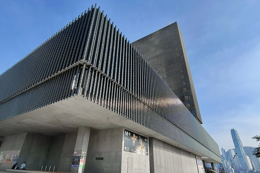 The exterior corner and ribbed facade of M+ in West Kowloon, Hong Kong. Photographed on 22 October 2024.