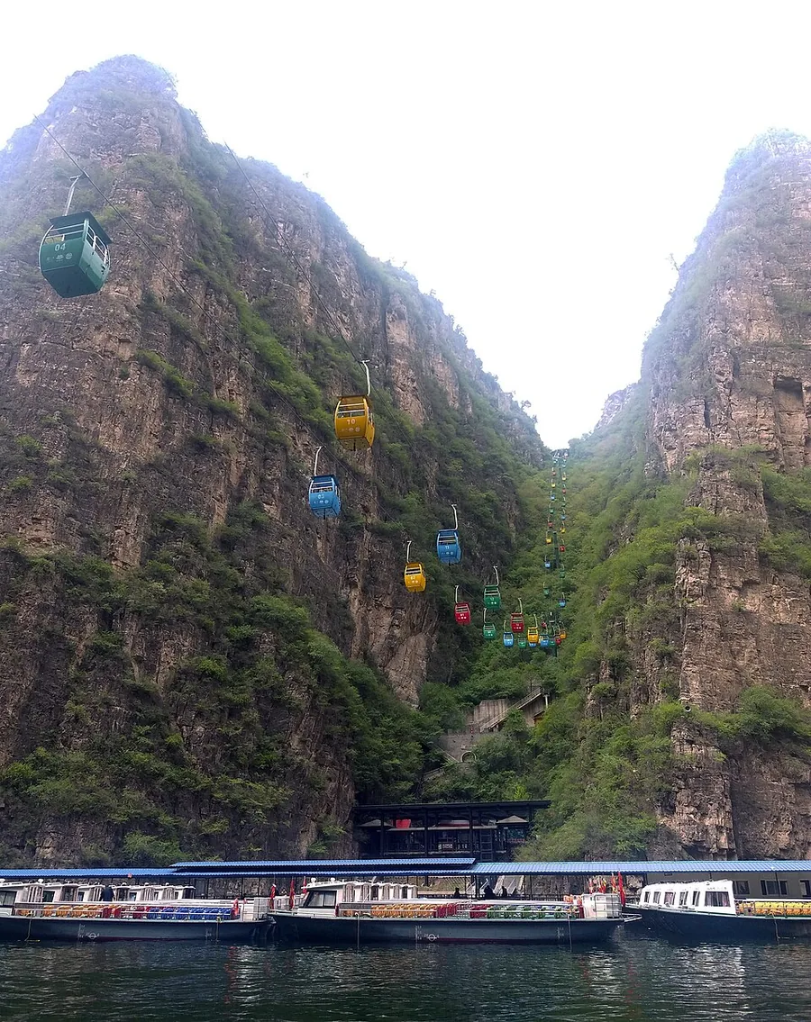 Cable cars above the water and cliffs at Longqing Gorge.