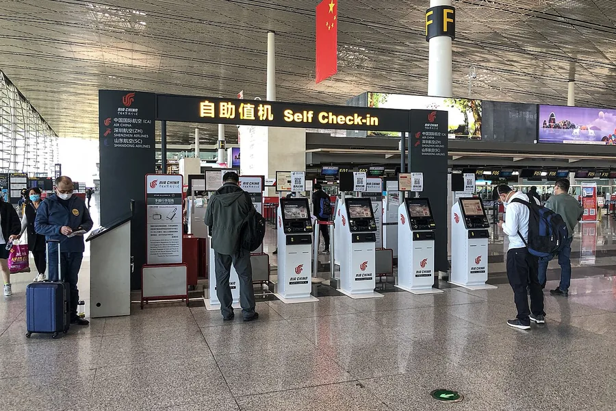 Air China self-service check-in kiosks inside Terminal 2 at Tianjin Binhai International Airport. Photographed on 26 April 2020.