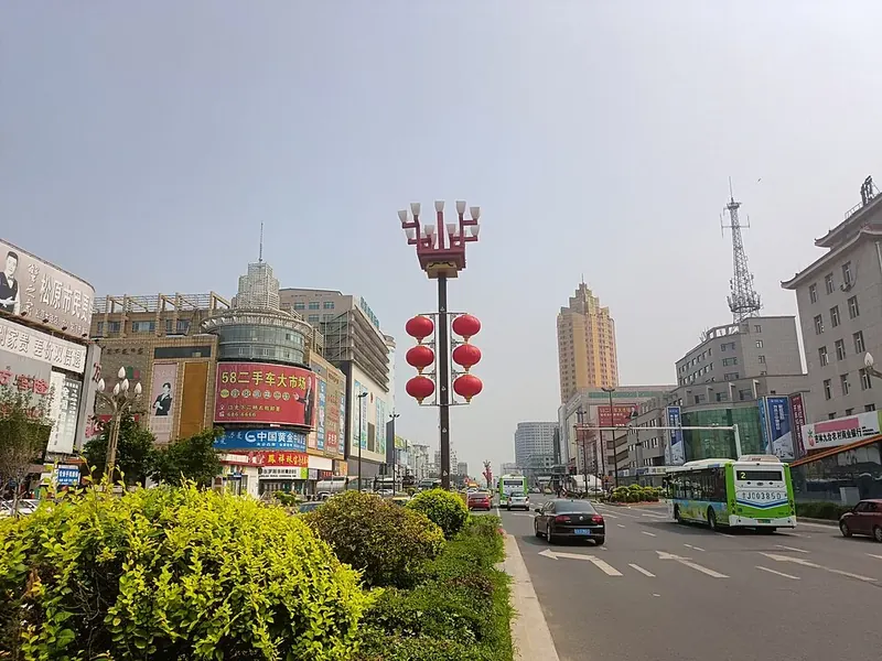 A commercial street scene in Songyuan (松原), showing everyday urban buildings and traffic.