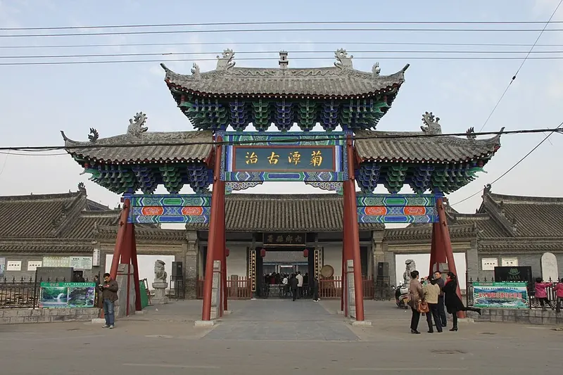Ornate painted stone archway at the entrance to the Neixiang Yamen Museum