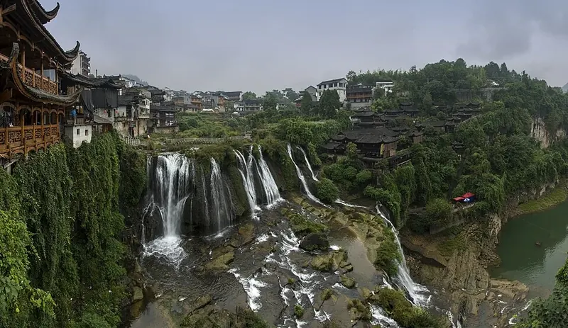 The waterfall and hillside buildings of Furong Town in Yongshun County (永顺县芙蓉镇), within Xiangxi Tujia and Miao Autonomous Prefecture.