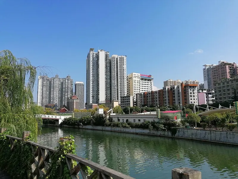 Riverside buildings and a bridge in Duyun.