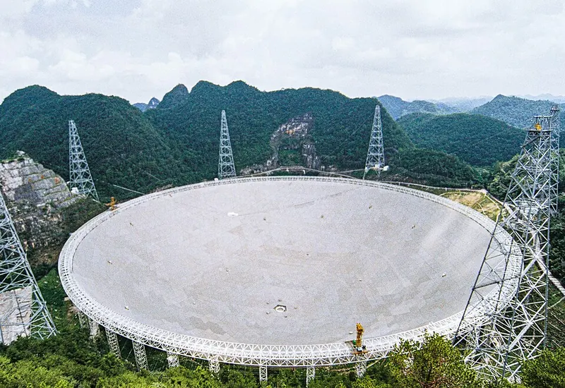 The FAST radio telescope in its mountain basin · 中国天眼FAST
