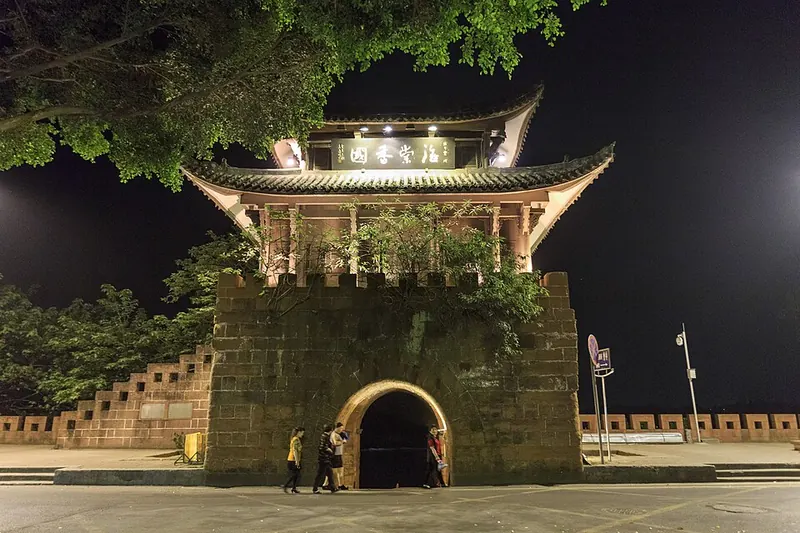 Lizheng Gate illuminated at night in Leshan.