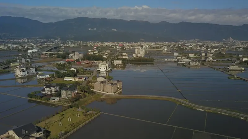 Fields and settlements on the Yilan plain (宜蘭平原), within Yilan County, with hills beyond.