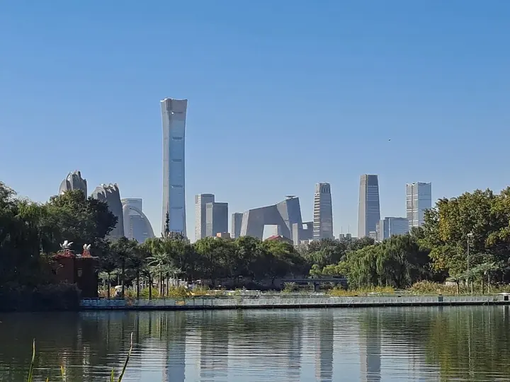 Chaoyang Park lake with the Beijing skyline beyond, in Chaoyang District.
