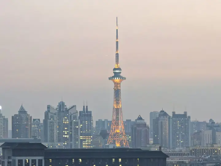 Dragon Tower above Harbin at dusk, photographed in October 2025 · 哈尔滨龙塔