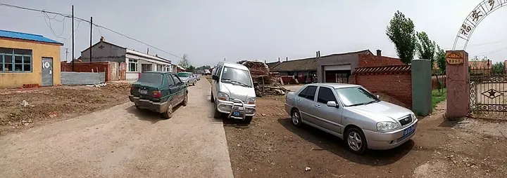 A village road and streetfront houses in Yushu, Changchun, Jilin. Source date: 23 May 2014 (original upload date).