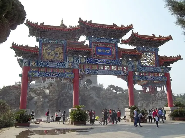 The painted gateway and rock-backed approach at Penglai, Yantai.