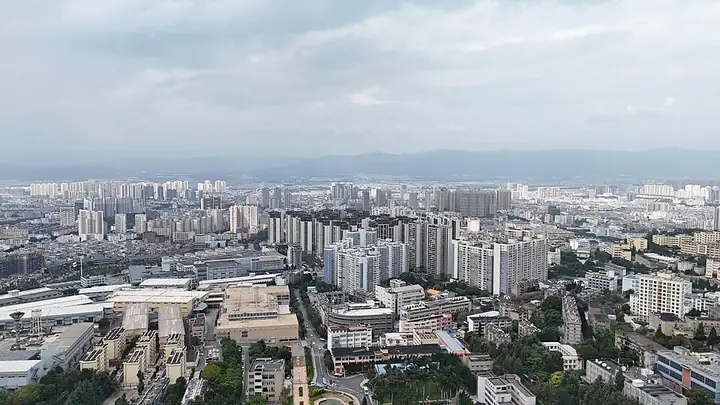 Aerial view of the Yuxi city skyline with distant mountains