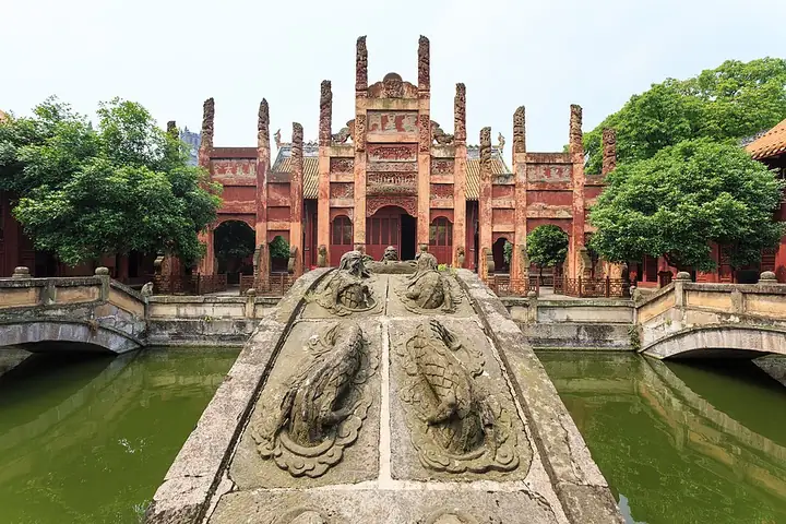Carved stone bridge over the Panchi pond leading to the temple's ornate gate