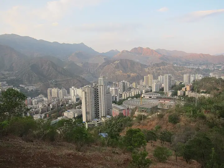 Urban buildings and surrounding hills in Dong District, Panzhihua.