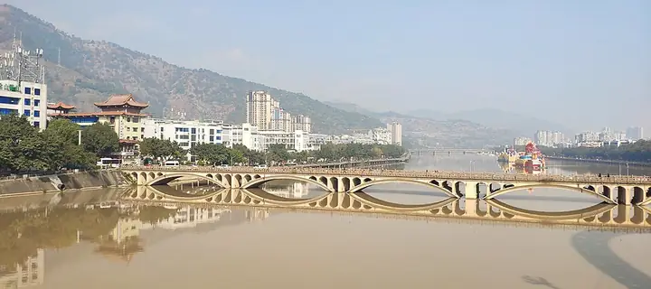 The Anning River bridge and nearby county-seat buildings in Miyi County.