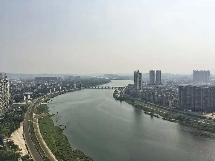The Fu River and urban waterfront in Jiangyou, photographed from the Lufugong building.