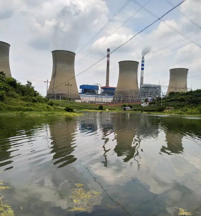 Cooling towers and a waterside view of the power station in Gantang Town, Qianxi.