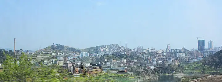 The skyline of Kaili, with hills and vegetation in the foreground.