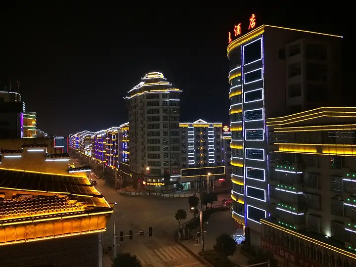 Illuminated streets and buildings in Cengong County at night.