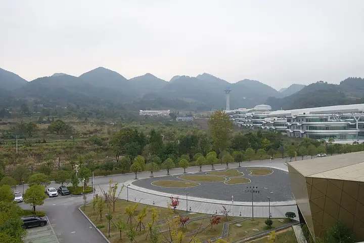 The visitor-area buildings and mountain landscape at the Tianyan scenic area in Pingtang County.