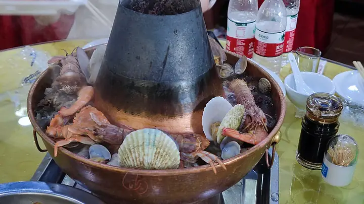 Shanhaiguan hun guo, pictured with seafood in a copper chimney hotpot.