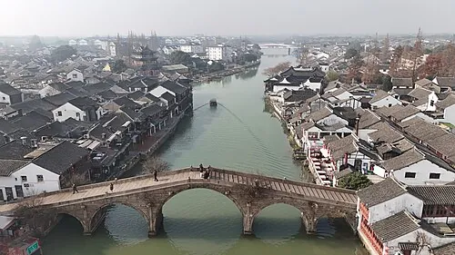 Canal, bridge and historic rooftops in Zhujiajiao Ancient Town, Shanghai · 上海朱家角古镇航拍