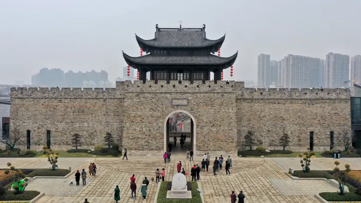 Stone and timber city gate tower with red lanterns at Wuhu's old city