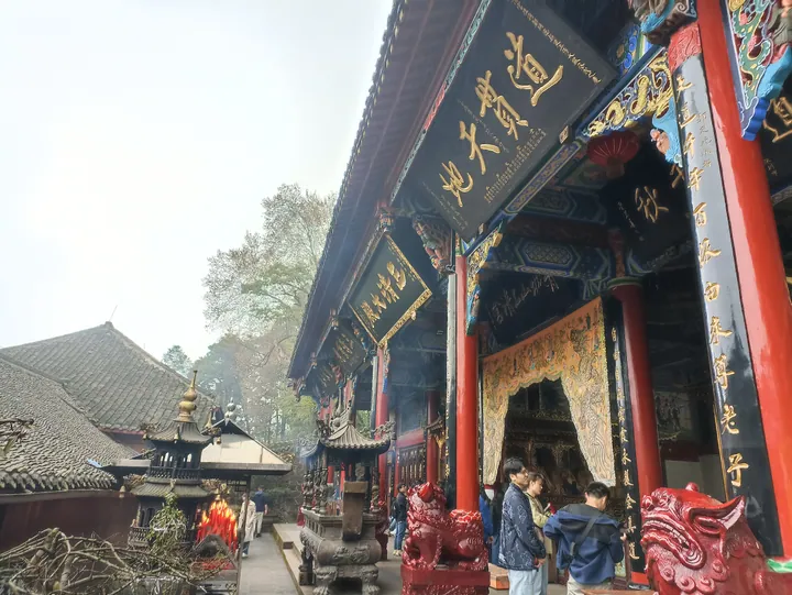 Ornate temple hall entrance at Shangqing Palace with visitors