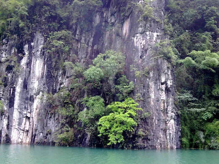 Forested limestone cliffs rising from the Furong River in Wulong District, Chongqing
