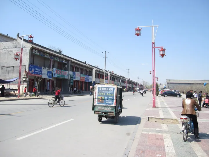 A street lined with shops near a temple in Quyang County, China