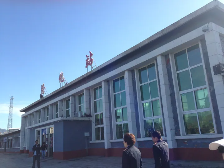 Exterior of Longhua Railway Station building under a clear sky
