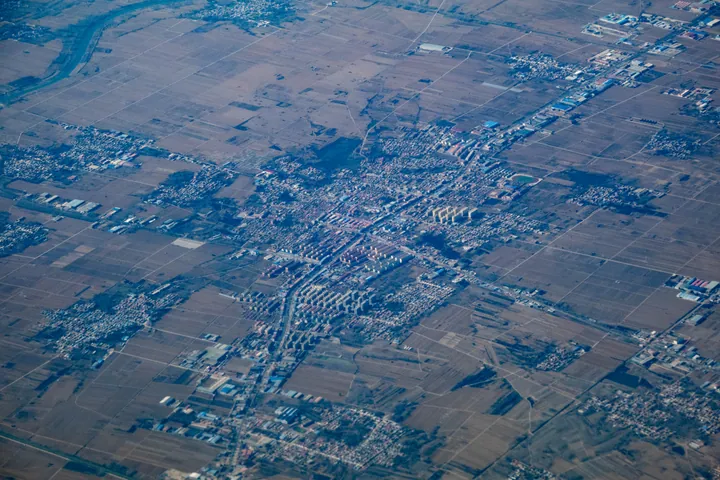 Aerial view of a small town surrounded by farmland in Botou
