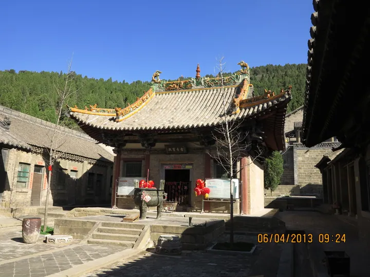 Two-story wooden temple hall with red lanterns in Gaoping