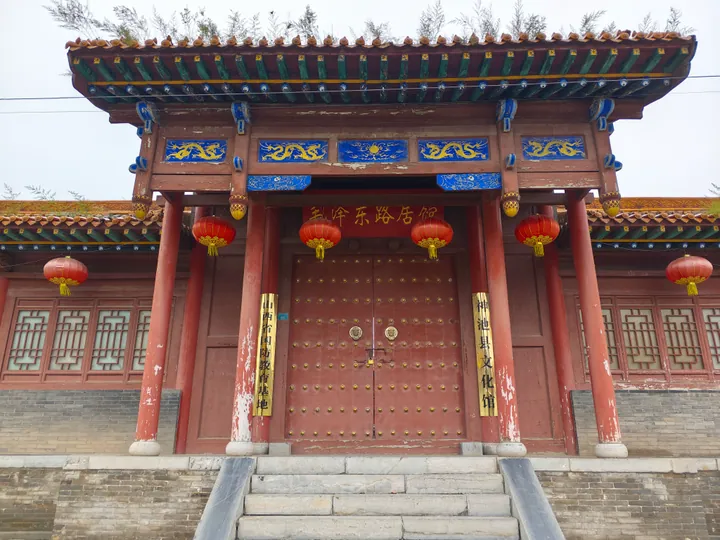 Ornate gatehouse of a historic memorial hall in Shenchi County